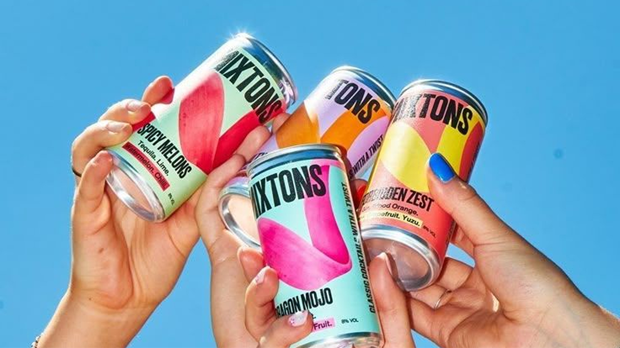 Hands raising cans of Tipsy Drops cocktails